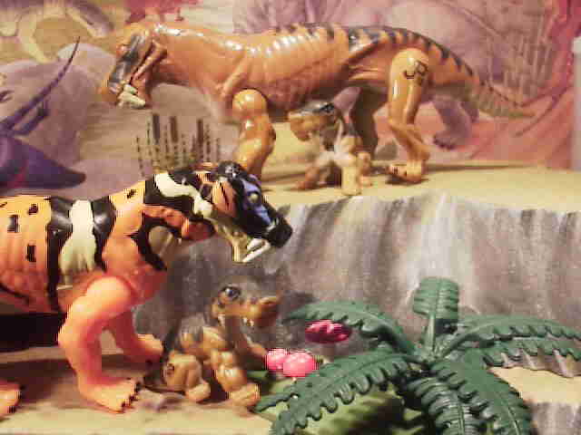 Hasbro's Jurassic Park Line Lycaenops. The tan original figure at the top center with the baby from the action figure blister card. Below is mutated Lycaenops with psychedelic colors.