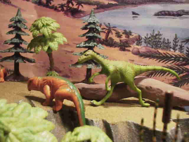 Staurikosaurus and a rhychosaur. Since neither of these animals is produced as a toy figure I used an anonymous dinosaur from the Rendition Cave woman figure for Staurikosaurus. To be a Staurikosaurus it should have a five-toed foot instead of the normal theropod three-toed foot. The Captorhinus (an Early Permian reptile) from a party favor set made in china most resembles the buck toothed rhychosaur Scaphonyx. 