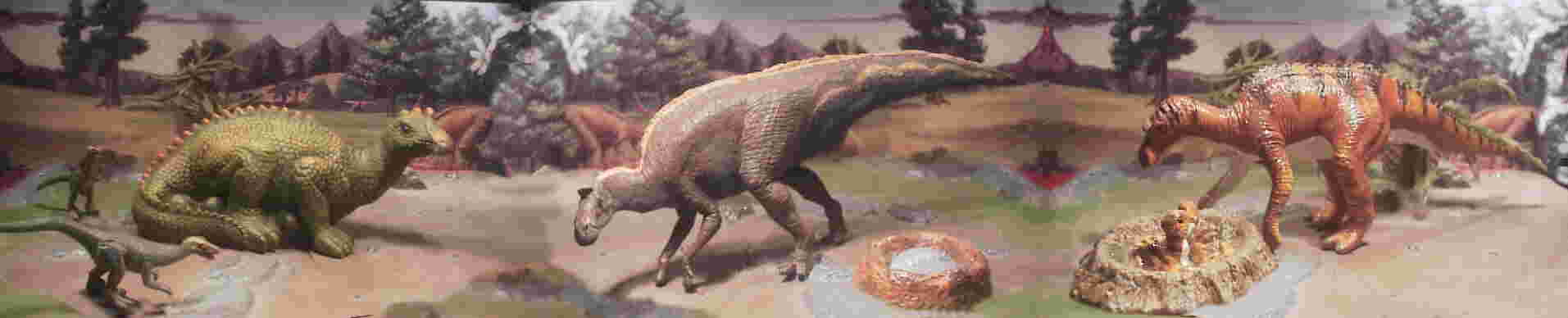 Much like the original Carnegie Safari Maiasaura, the green Faro figure from Italy is sitting on the eggs. It seems unlikely that this was practical given the weight of Maiasaura. The Troodon are from the National Geographic MicroMachine series, and in the center is a Battat figure with a JP 3 nest and egg from the mold kit. Last is the current Carnegie Safari Maiasaura with nest.